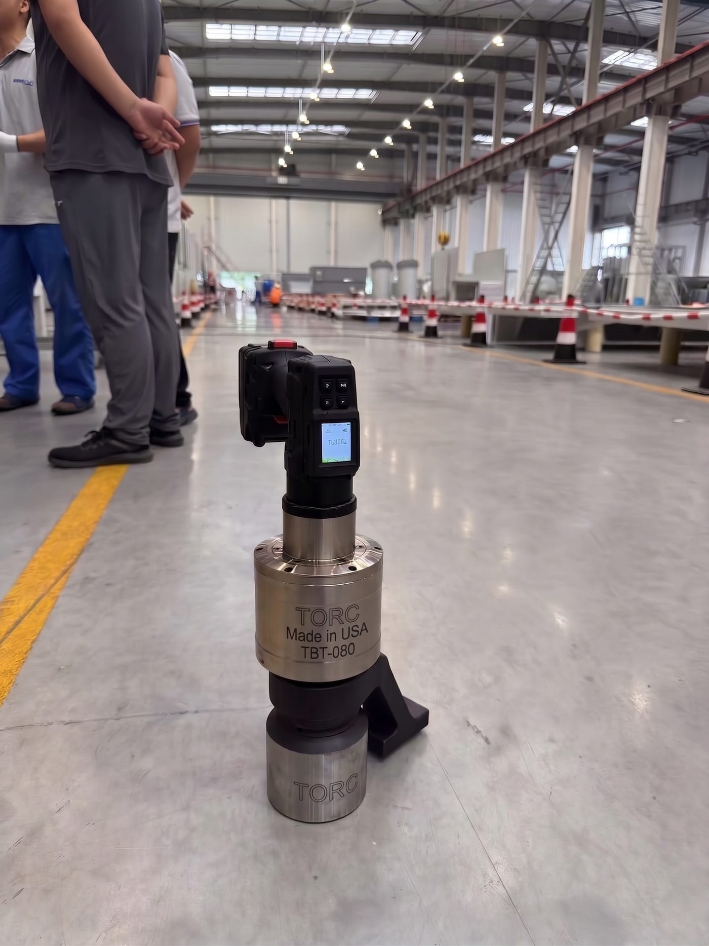 TORC TBT-080 cordless torque wrench, Made in USA, shown on the floor of an industrial facility
